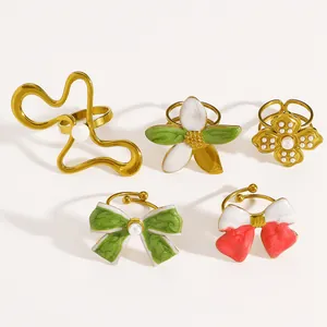 Detail view of colorful vintage enamel rings featuring artistic flower and bow designs