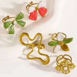 Close-up detail of vintage colorful enamel rings with bow and flower motifs in gold finish