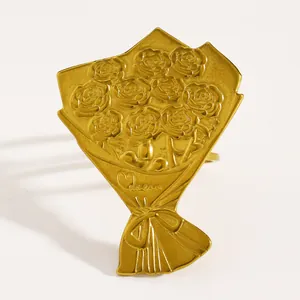 Detailed view of a vintage gold-toned stainless steel ring with a rose bouquet design