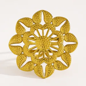 Detailed close-up of a vintage golden flower open ring with textured petal designs