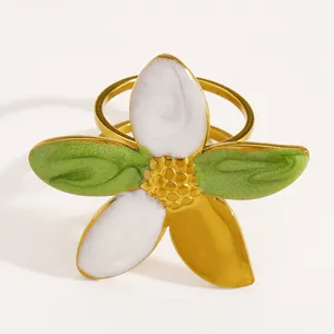 Detailed close-up view of vintage gold-plated stainless steel ring with enamel flower