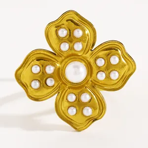 Detailed macro shot of vintage gold flower ring with elegant white pearl embellishments