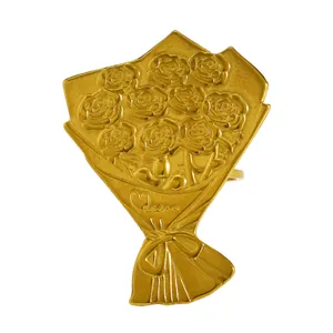 Macro view of a gold stainless steel ring with an engraved rose flower bouquet design