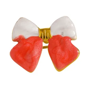 Detailed macro view of the vintage red and white enamel bow pattern on the ring band