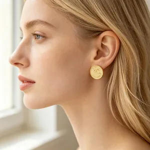 Gold plated stainless steel zodiac coin stud earrings for women featuring relief design