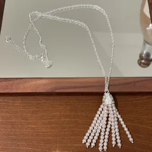 Detailed view of a vintage Bohemian pearl tassel sweater chain necklace with silver chain