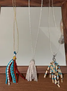 Detailed view of three Bohemian beaded tassel necklaces with pearls and vintage elements