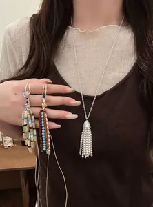 Close-up detail of Bohemian style pearl and colorful beaded tassel long necklaces
