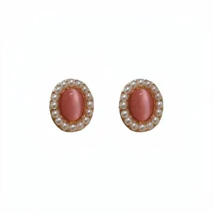 Retro Hepburn style oval pink cat's eye stone stud earrings with a delicate pearl border