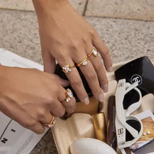Lifestyle detail view of 18k gold plated stainless steel zircon rings worn on a hand