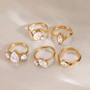 Close-up display of five unique 18k gold plated stainless steel CZ rings in a set