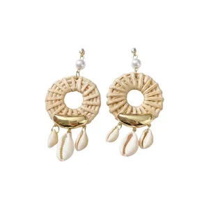 Bohemian rattan woven hoop earrings with natural cowrie shell tassels and faux pearls.
