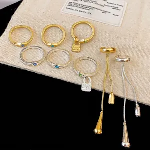 Vintage gold and silver jewelry set with rings, charms, and waterdrop tassel ear cuffs