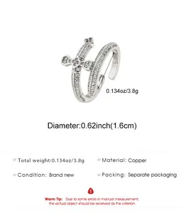 Macro view of a silver double cross open ring with sparkling cubic zirconia detailing.