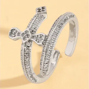 Detailed macro view of silver double cross ring with shimmering cubic zirconia