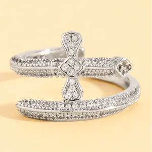Exquisite silver-colored double cross open ring with pavé-set shimmering cubic zirconia.