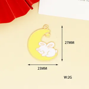 Detailed view of the 27x23mm yellow crescent moon and sleeping rabbit enamel charm