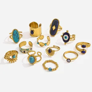 Close-up of Bohemian gold stainless steel rings set with Evil Eye and blue stones.