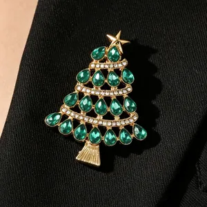 Gros plan d'une broche sapin de Noël ornée de cristaux verts sur le revers d'un blazer