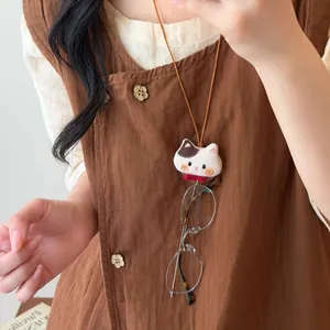 Cute fabric cat plush necklace with leather cord used as a stylish glasses holder