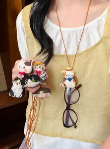 Detailed view of cute handmade fabric cat doll necklace with leather cord and glasses hanger