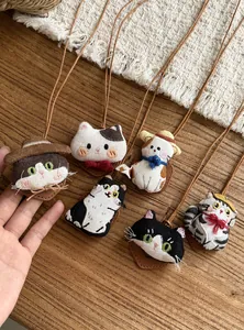 Close-up detailed view of six cute handmade cat fabric doll necklaces with leather cords