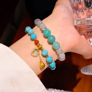 Vista dettagliata di braccialetti in turchese e stile giada con ciondolo a forma di zucca