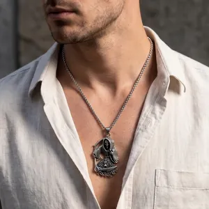 Close-up of Gothic Grim Reaper stainless steel pendant necklace on male model
