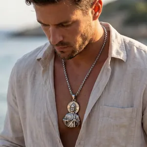 Detailed shot of a stainless steel religious pendant on a thick chain worn by a model