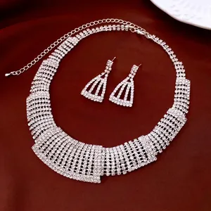 Elegant silver-toned rhinestone trapezoid necklace and earrings set for luxury style.
