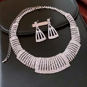 Luxurious silver-toned rhinestone necklace and trapezoid earring jewelry set for women.