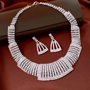 Elegant rhinestone necklace and trapezoid earring jewelry set on luxurious brown satin cloth