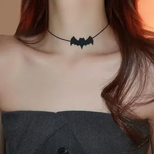 Close-up detail showing a stylish black mesh velvet bat choker worn by a fashion model