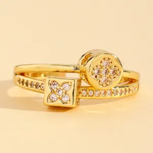 Close-up of gold stainless steel stackable ring with zircon four-leaf clover detail