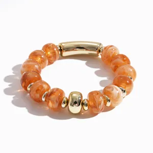 Vintage elastisches Armband mit orangefarbenen Marmorperlen und goldenen Metallakzenten