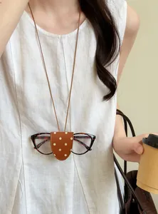 Close-up of polka dot leather magnetic glasses clip necklace worn as a fashion accessory