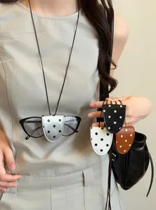 Detail view of portable polka dot leather magnetic glasses clip necklace in multiple colors