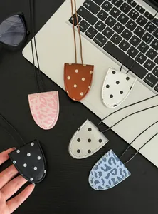 Multiple stylish leather magnetic sunglasses clip necklaces displayed on a laptop