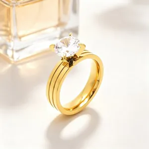 Elegant gold stainless steel four-prong zircon ring with double groove band