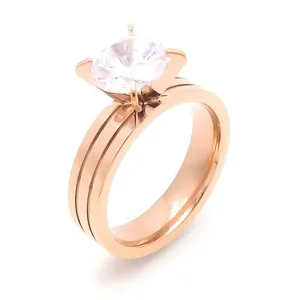 Elegant rose gold stainless steel ring with four-prong zircon stone on white background