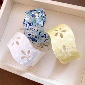 Elegant acrylic hollow flower open cuff bracelets featuring three colorful marble patterns.