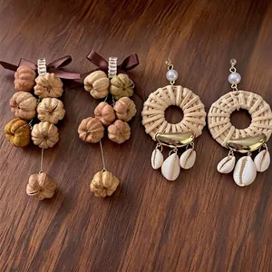 Bohemian style ribbon bow and woven rattan dangle earrings with natural shells and zircons