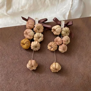 Elegant bohemian zircon ribbon bow drop earrings with unique autumn pumpkin beads.