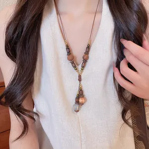 Close-up of a vintage bohemian necklace with wooden beads and tiger eye stones