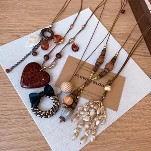 Detailed view of mixed Bohemian vintage tassel necklaces with leopard heart