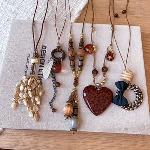 Close-up of Bohemian retro necklaces with leopard heart and shell pendants