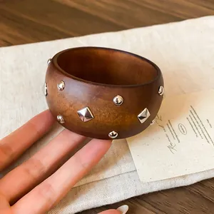 Brazalete de madera retro con tachuelas plateadas en un diseño de moda de alta gama