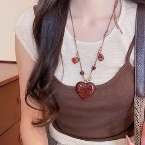 Detailed shot of a vintage bohemian necklace with leopard heart and tiger eye beads