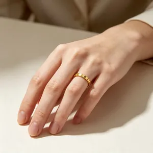 Minimalist mechanical faceted gear ring in 3mm gold-plated stainless steel on finger