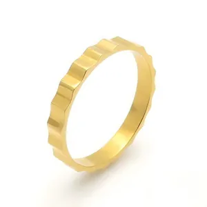Modern minimalist gold mechanical gear ring with serrated edges in polished stainless steel